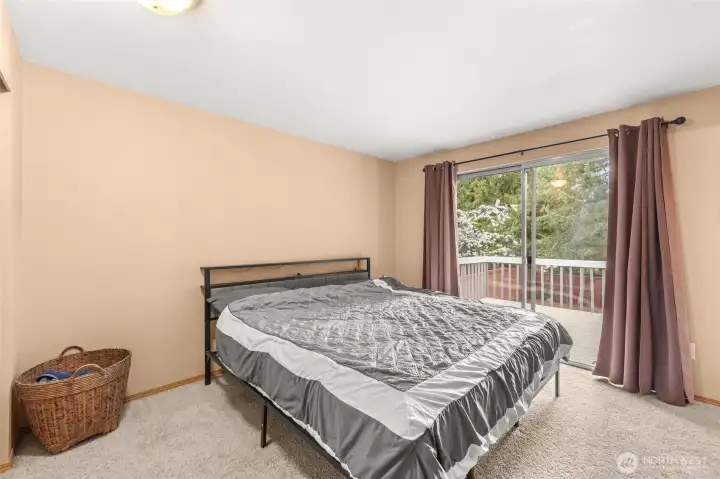 The master bedroom has a slider to the deck and three quarter bath