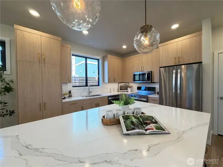 Massive quartz island with eating space and double sided storage.