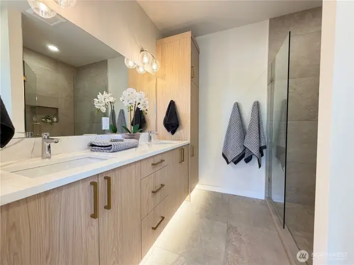 Primary en suite with double vanity and motion activated under cab lighting.