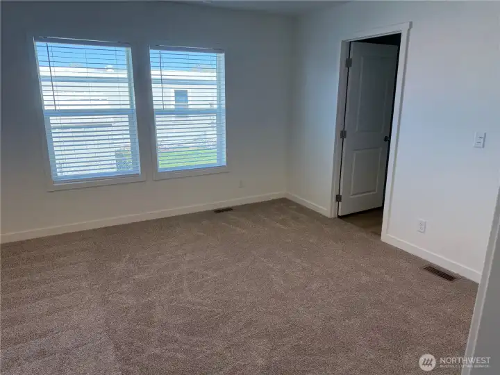 Primary bedroom looking at walk in closet.