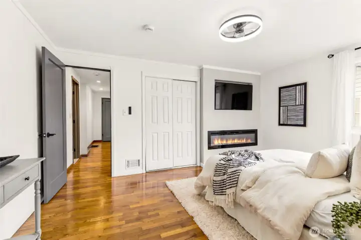The generously sized primary room offers modern updates, cozy ambiance, and room to truly unwind.
