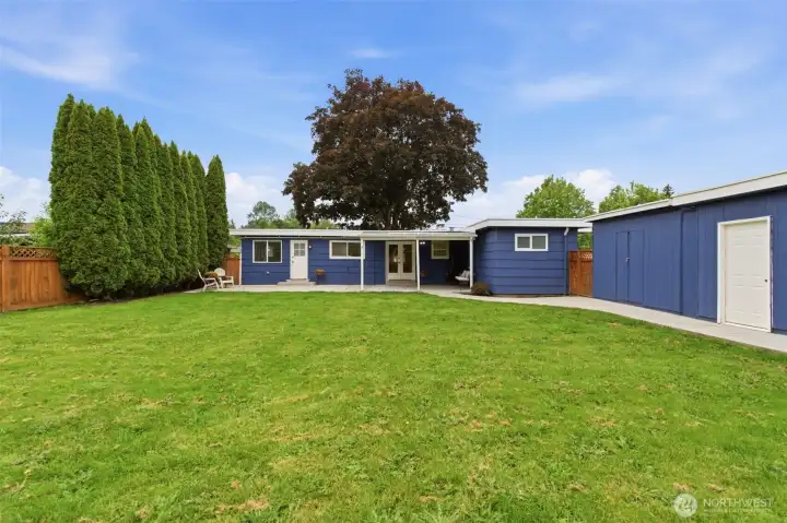 A dedicated storage shed keeps tools, gardening supplies, and outdoor equipment organized and easily accessible.