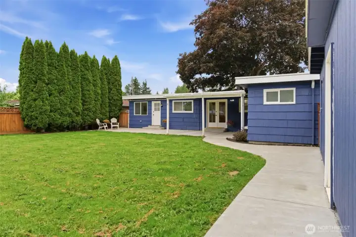 Thoughtfully designed concrete pathways connect the home, garage, and shed, adding convenience and functionality throughout the property.