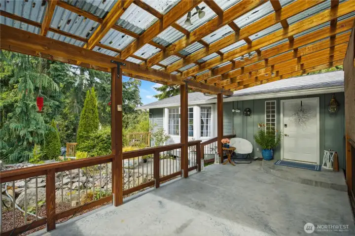 Main house front entrance. Large covered area and water feature.