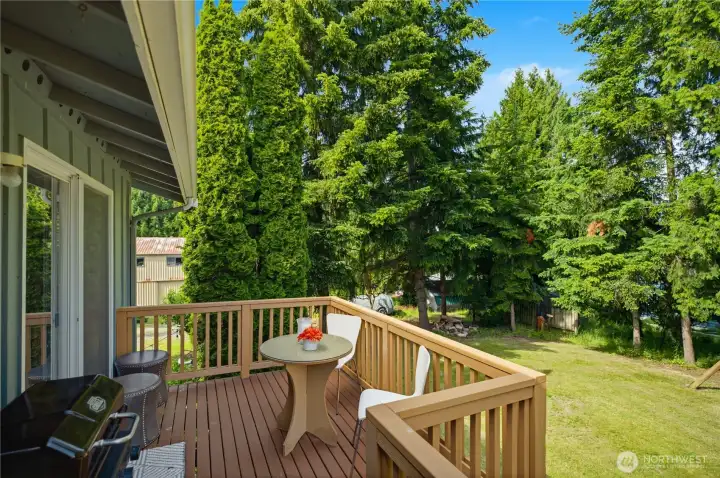 Partial wrap around deck with huge yard.