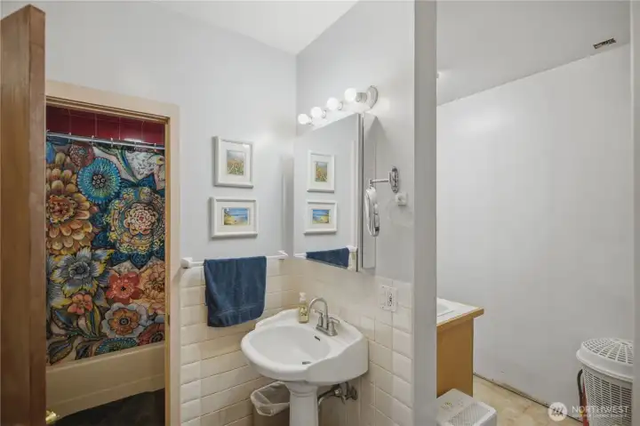 Bathroom with laundry room and extra storage.