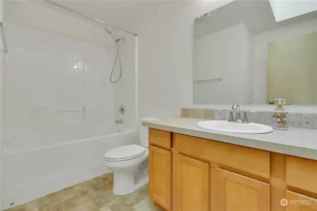 Hall bath with tub/shower combo.