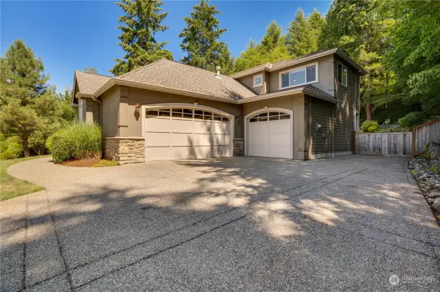 Three car garage with additional space for parking.