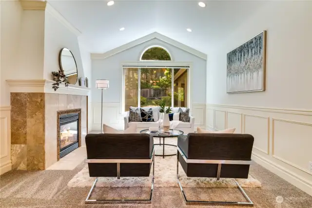 Formal living room with vaulted ceilings and gas fireplace.