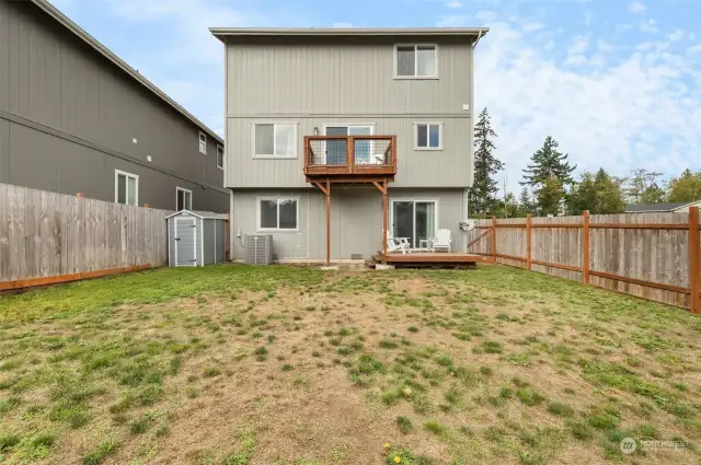 Fully fenced back yard, back of home.