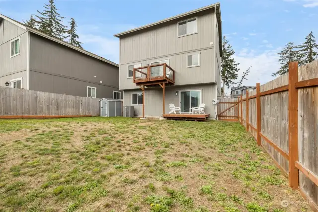 Fully fenced back yard. Back of home.