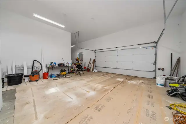 Large 2-car attached garage with built-in storage and/or workshop area.