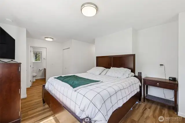 Primary bedroom with dual closets and full private bath. This space is SO bright and cheery!