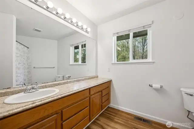 Guest bathroom has a TON of space, with full tub and room to MOVE.