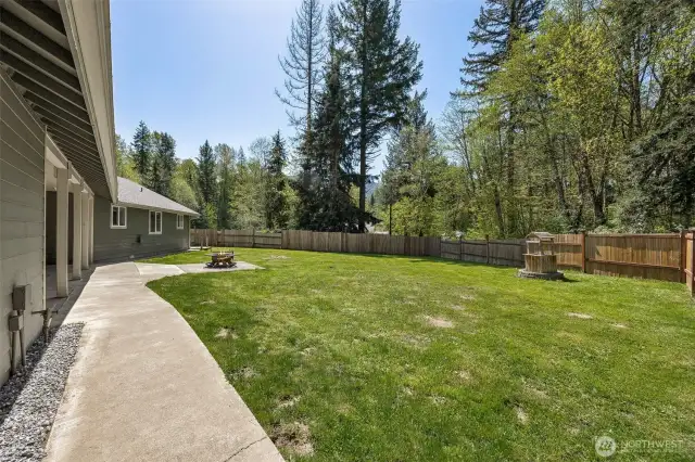 Fully fenced front yard with wrap around sidewalk.