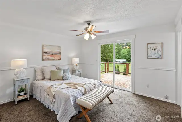 The primary suite enjoys a sliding door to the expansive deck with views to the beautiful yard.  There is so much privacy here on this quiet 2.47 acres.