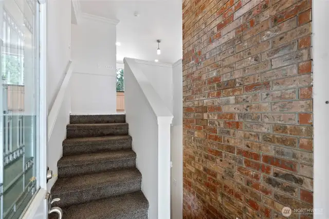 Entryway into this split level home includes a wide outdoor concrete stairway and French doors that both easily open.