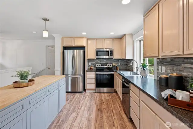 The island has butcher block counters and loads of storage underneath.