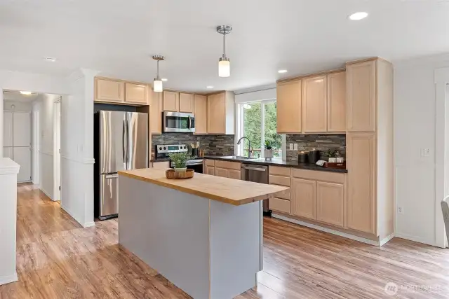 The kitchen is open to both the dining room and living room, allowing for easy entertaining.