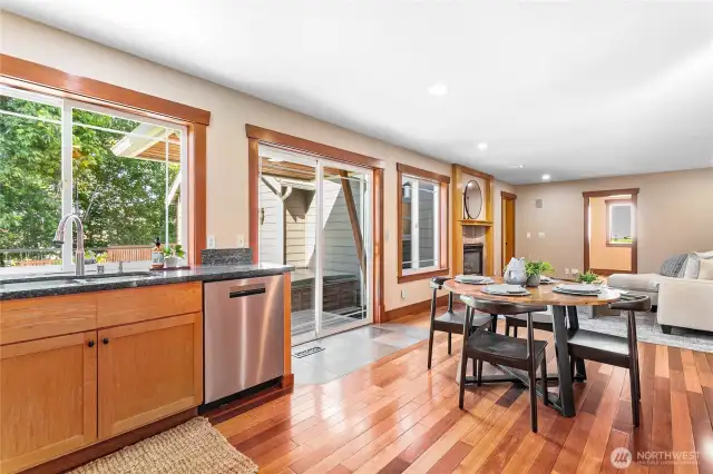 A beautiful view of the backyard, gardens and patio from the kitchen sink