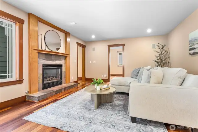 The family room next to the kitchen and eating area with a cozy gas fireplace