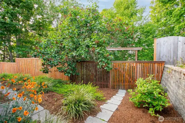 The path and garden gate that leads to the trail