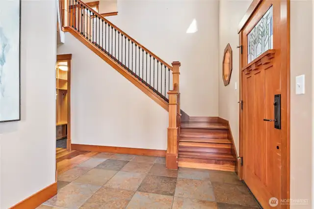 The welcoming front entry with vaulted ceilings and wood staircase