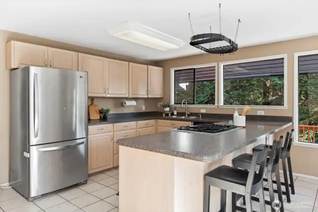 Kitchen with eat up bar and gas cooktop.