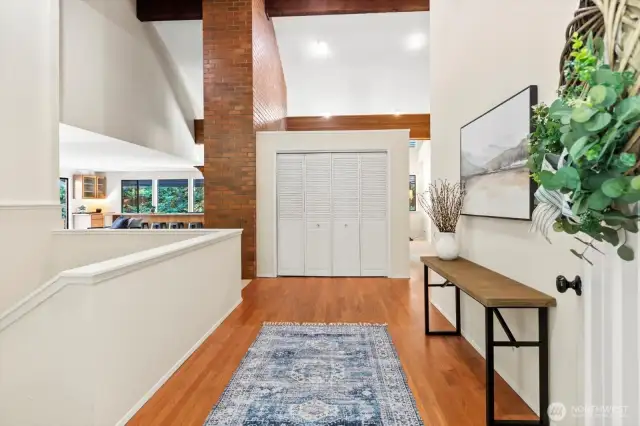 Entry with hardwoods and vaulted ceilings.