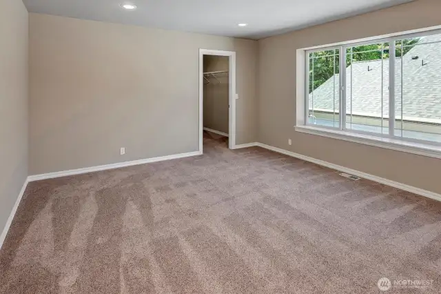 Bedroom with walk-in closet on upper floor