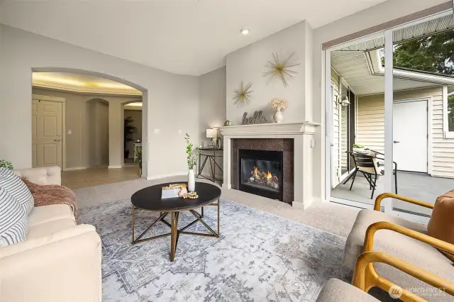 Pictured here is the living room, entrance to the condo, bonus room and personal balcony.