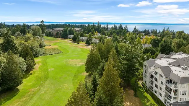 First Green sits next to the Harbour Pointe Golf Course offering views of the green and evergreens.