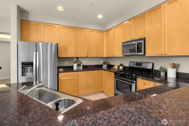 Entertain with this roomy kitchen. Complete with a gas stove, granite countertops, and stainless steel appliances.