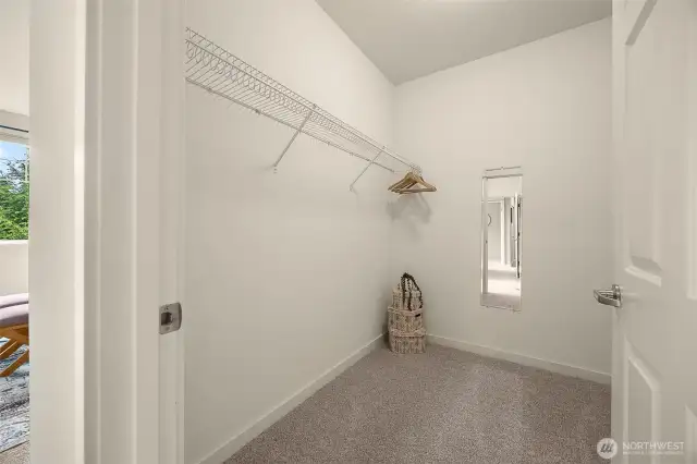 Spacious primary walk-in closet.