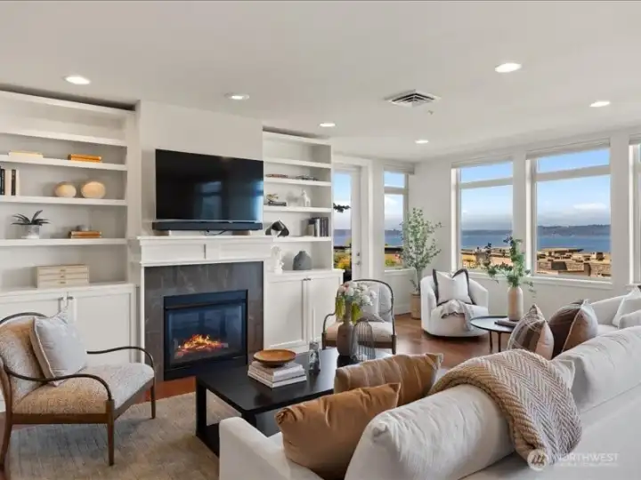 Custom built-in cabinetry surrounds the cozy gas fireplace . . .