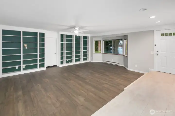 Entry to spacious living room with built in shelves.