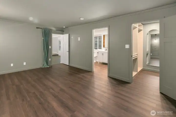 Primary suite with adjoining three quarter bath and walk-in closet.