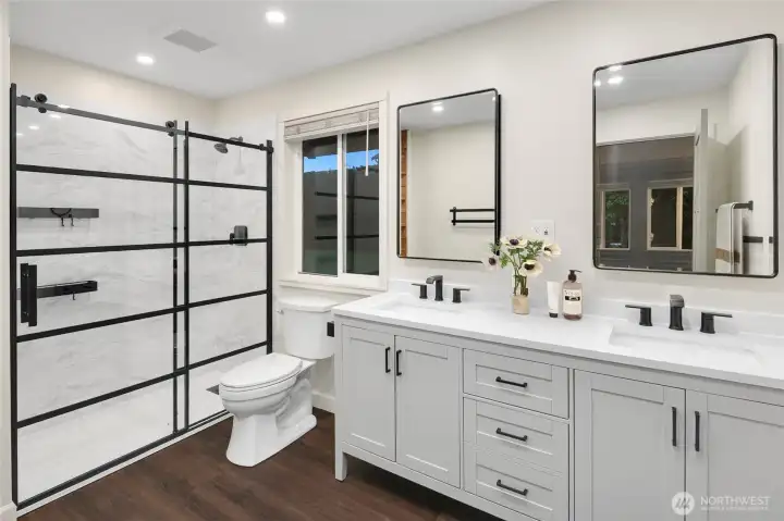 Primary three-quarter bath, virtually staged.