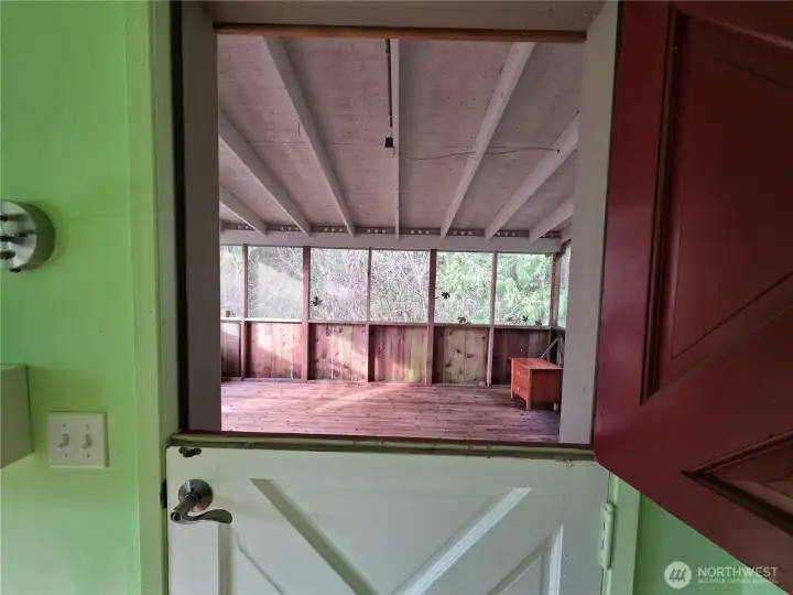 Dutch door from primary bedroom to screened porch that leads to hot tub,