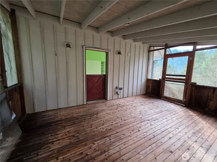 screened covered porch off the primary bedroom, leads out to the new salt water hot tub