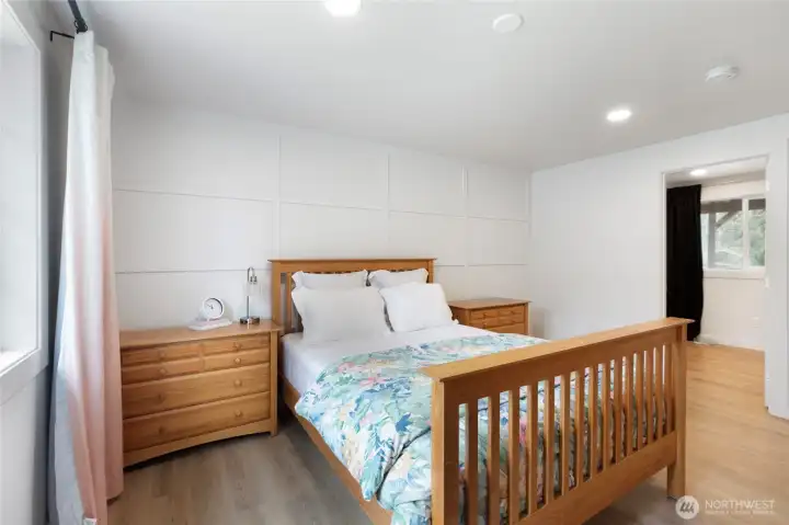 Another view of the primary suite, with a glimpse of the oversized walk in closet.