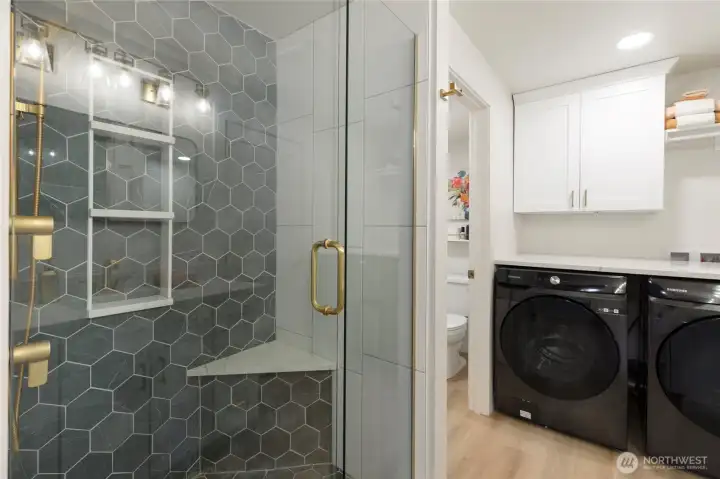 Massive remodeled walk-in shower featuring floor-to-ceiling designer tile, glass enclosure with upscale fixtures. Spa-inspired design.