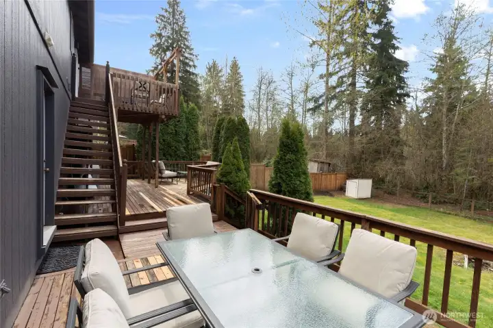 Spacious multi-level deck offers plenty of room for outdoor dining and entertaining, with easy access between upper and lower levels. Overlooks a private, grassy yard and backs to a greenbelt.