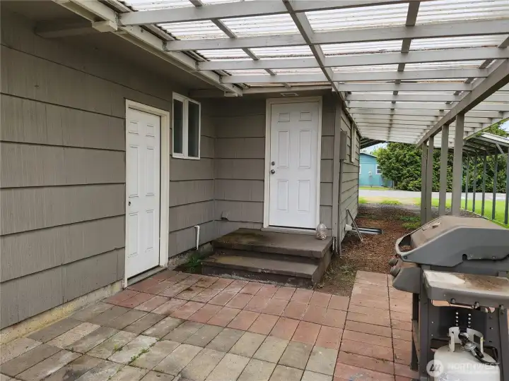 Back porch, door to left to the garage, door up the steps goes to utility room