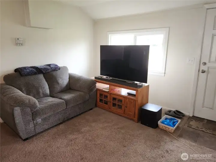 View of livingroom, front door to right of photo
