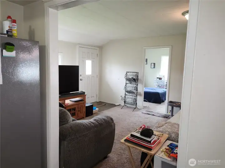 Livingroom from kitchen.  Front door t left and bedroom 1 in view