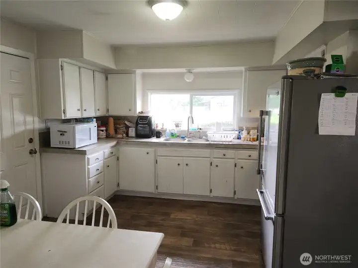 Kitchen with stainless steel appliances.  Door to left of photo goes into the garage
