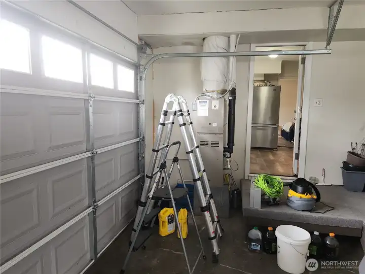Garage, furnace in view and kitchen