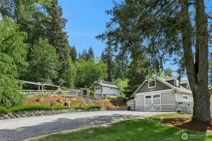 Driveway to shop with ample space for parking with the 2-car garage up top.