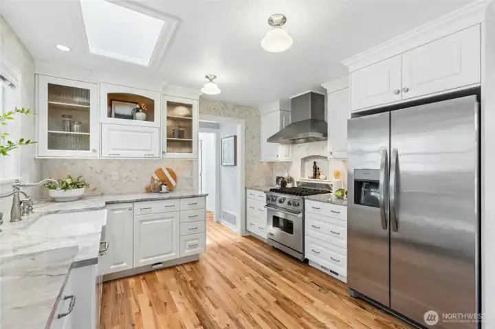 Viking gas stove & range hood with beautiful tile surround.